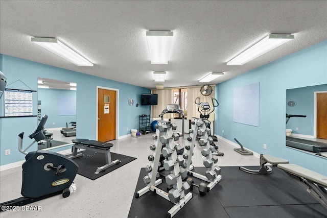 exercise room featuring a textured ceiling