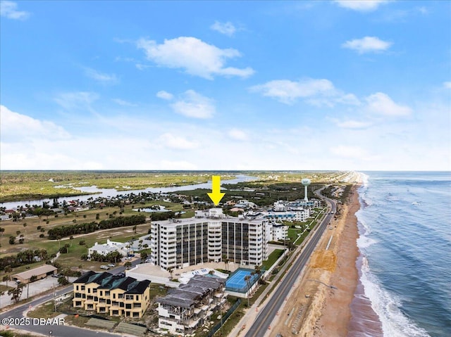 birds eye view of property with a view of the beach and a water view