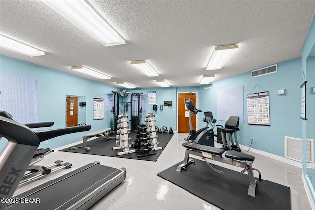 gym featuring a textured ceiling