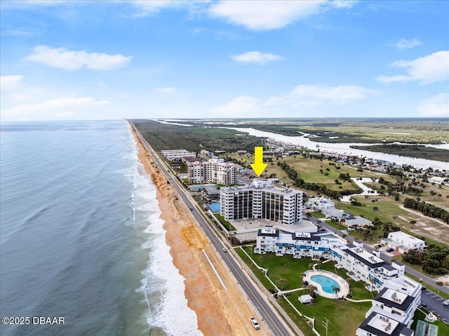 birds eye view of property with a beach view and a water view