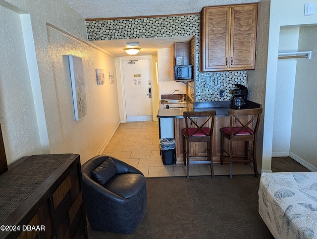 kitchen with tasteful backsplash and light tile patterned floors