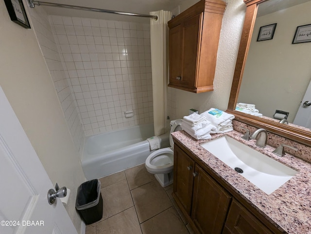 full bathroom featuring toilet, tiled shower / bath, tile patterned floors, and vanity