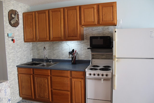 kitchen with white appliances, a textured ceiling, sink, and tasteful backsplash