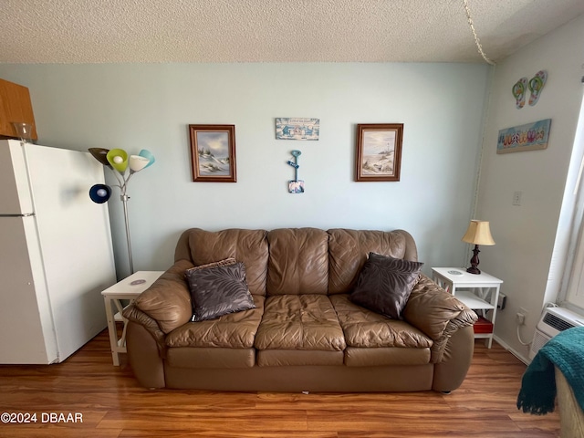 living room with hardwood / wood-style flooring and a textured ceiling