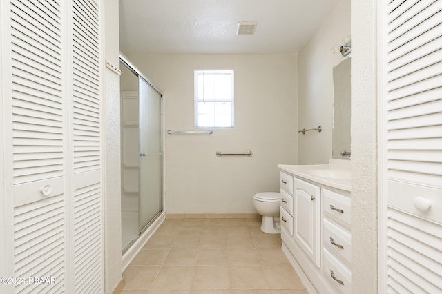 bathroom with tile patterned flooring, a textured ceiling, vanity, an enclosed shower, and toilet