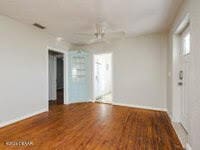 spare room with wood-type flooring