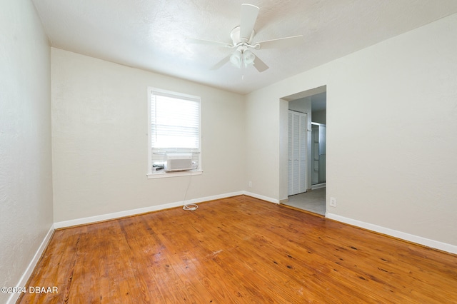 empty room with hardwood / wood-style flooring and ceiling fan