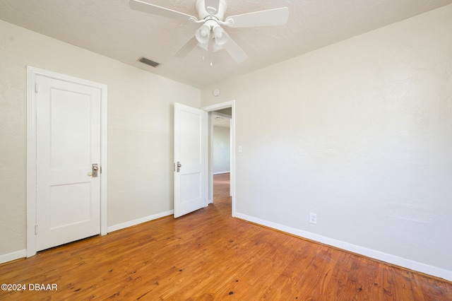 unfurnished bedroom with hardwood / wood-style floors and ceiling fan