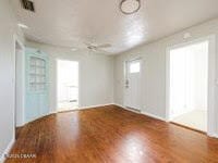 spare room with wood-type flooring