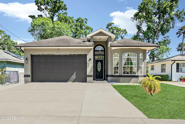 view of front of home with a yard and a garage