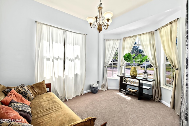 sitting room featuring a chandelier and carpet floors