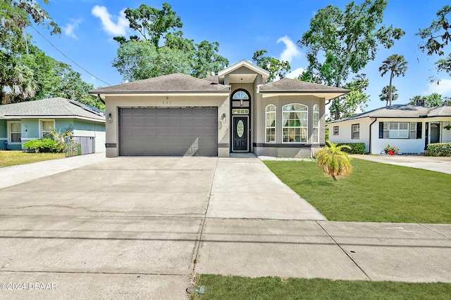 ranch-style home featuring a garage and a front yard