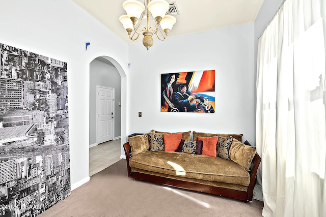 living room featuring carpet flooring and an inviting chandelier