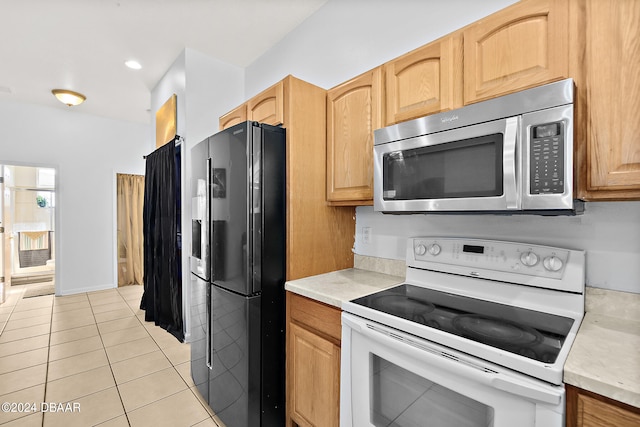 kitchen with electric stove, black fridge with ice dispenser, light tile patterned floors, and light brown cabinets