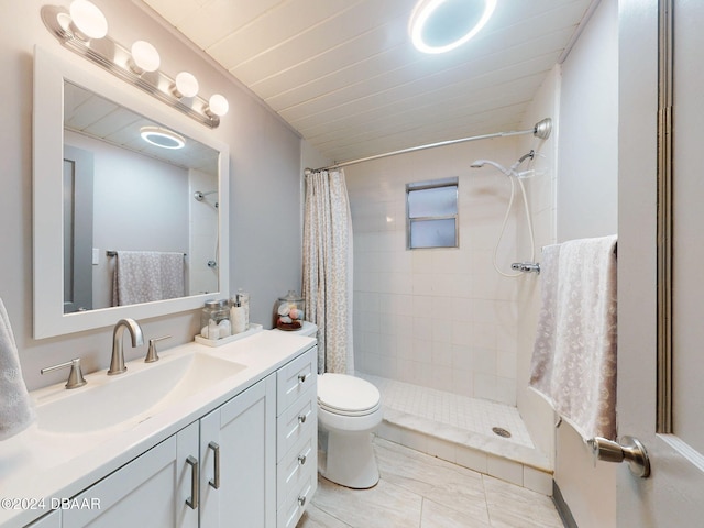 bathroom featuring a shower with shower curtain, tile patterned floors, vanity, and toilet