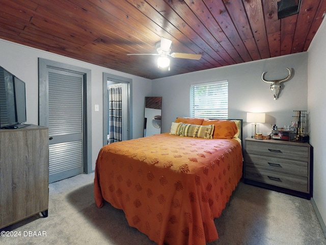 carpeted bedroom with ceiling fan and wooden ceiling