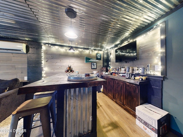 bar featuring a wall mounted air conditioner, wood walls, and light hardwood / wood-style flooring