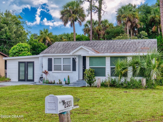 single story home featuring french doors and a front yard