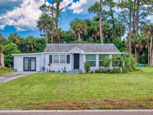 ranch-style home featuring french doors and a front yard