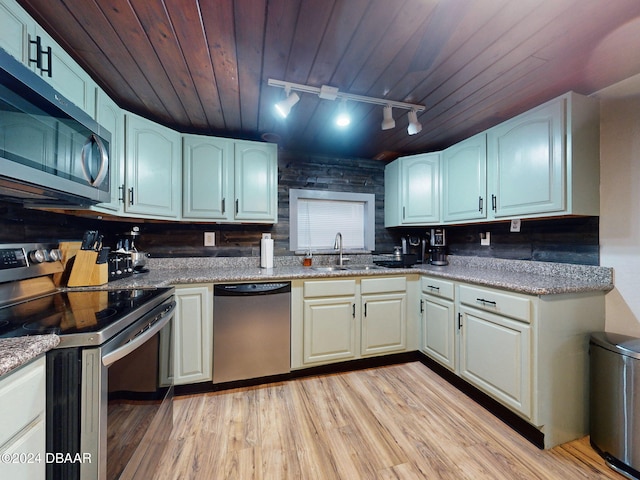 kitchen with appliances with stainless steel finishes, light wood-type flooring, track lighting, and wooden ceiling