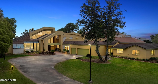 view of front of property featuring a yard and a garage