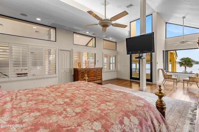 bedroom featuring light hardwood / wood-style flooring, high vaulted ceiling, and ceiling fan