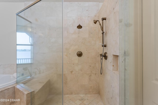 bathroom featuring independent shower and bath