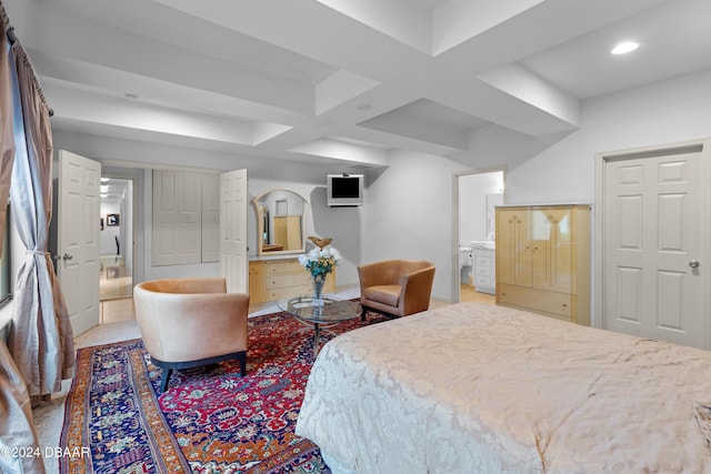 bedroom with beam ceiling, ensuite bathroom, carpet, and coffered ceiling