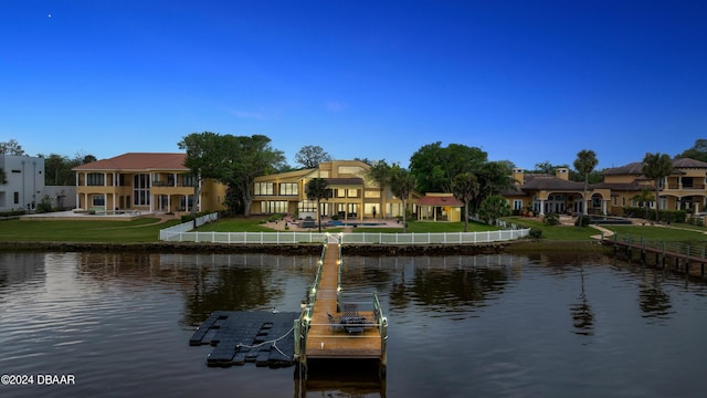 view of dock featuring a water view and a lawn