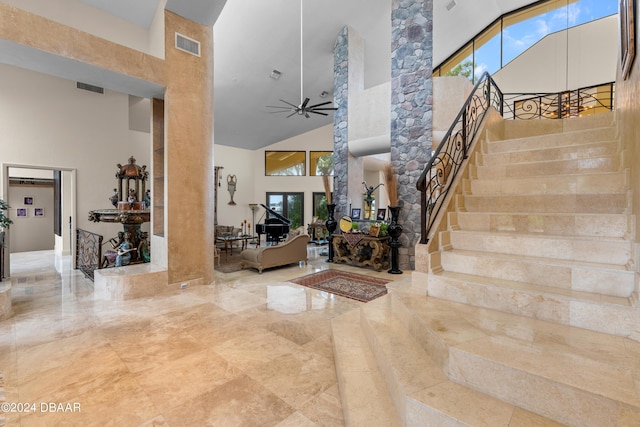 entryway with ceiling fan, a healthy amount of sunlight, and high vaulted ceiling