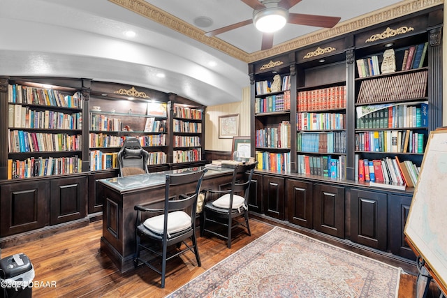 home office with wood-type flooring, built in features, ceiling fan, and wood walls