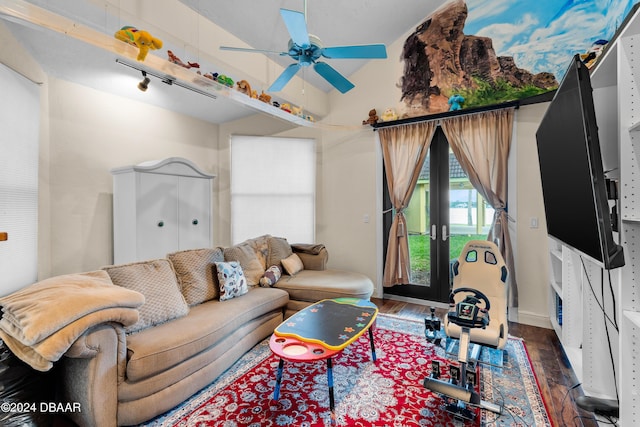 living room with ceiling fan, french doors, rail lighting, dark hardwood / wood-style flooring, and vaulted ceiling