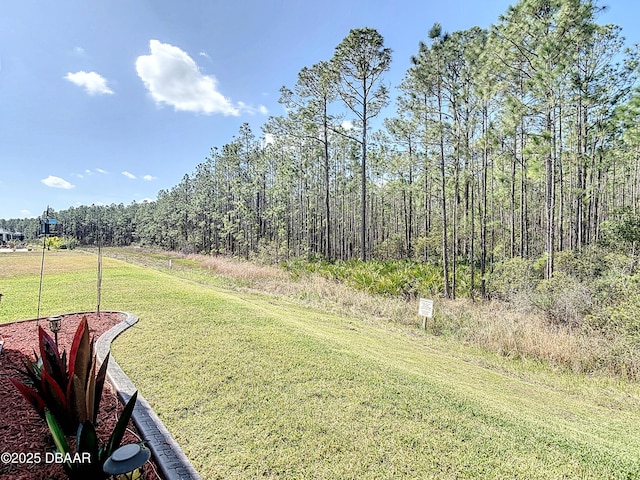 view of yard with a wooded view