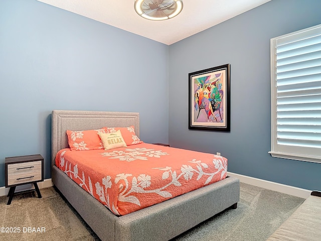 carpeted bedroom featuring baseboards