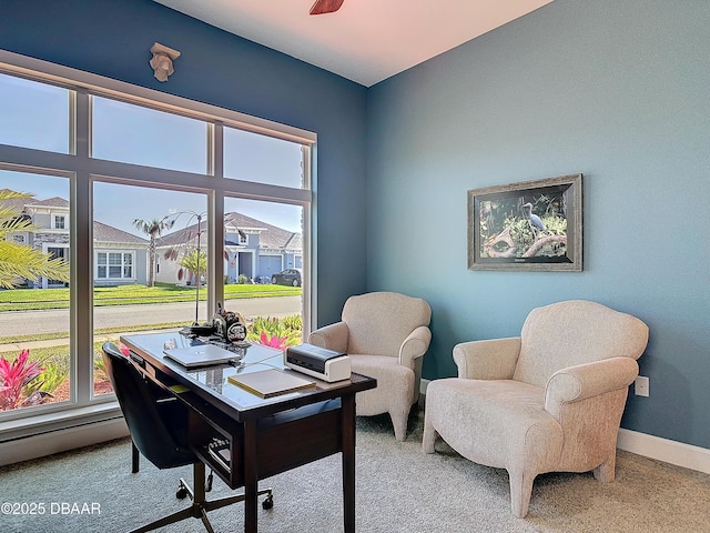 office area with a ceiling fan, carpet, a residential view, and baseboards