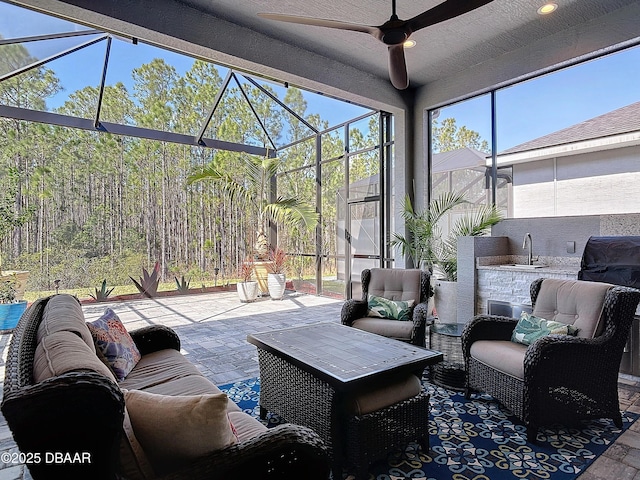 sunroom featuring a healthy amount of sunlight and ceiling fan