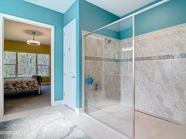 ensuite bathroom with a walk in shower, ensuite bath, tile patterned flooring, and baseboards