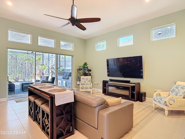 living room featuring recessed lighting, ceiling fan, baseboards, and light tile patterned flooring