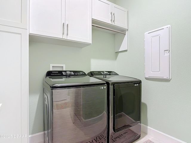 laundry room featuring independent washer and dryer, cabinet space, and baseboards