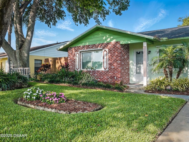 708 Egret Ct, Edgewater, FL 32141 - ranch-style home with brick siding and a front lawn