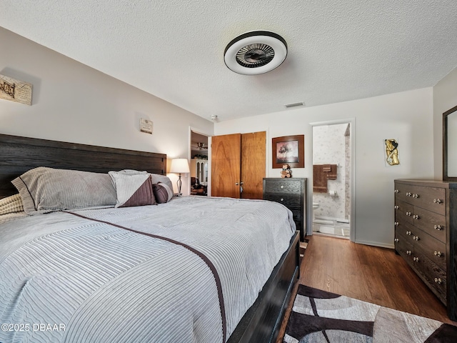 708 Egret Ct, Edgewater, FL 32141 - bedroom with dark wood-style floors, connected bathroom, and a closet