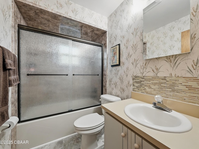 708 Egret Ct, Edgewater, FL 32141 - full bath with wallpapered walls, vanity, toilet, and combined bath / shower with glass door