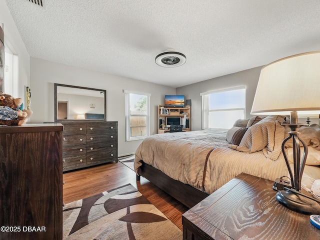 708 Egret Ct, Edgewater, FL 32141 - bedroom with wood finished floors and a textured ceiling