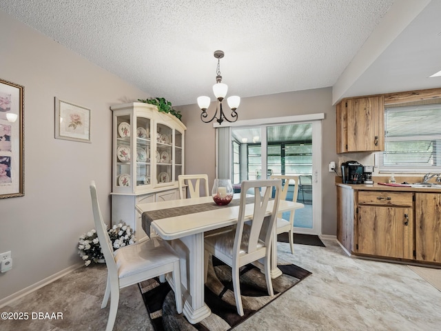 708 Egret Ct, Edgewater, FL 32141 - dining room with a chandelier, a textured ceiling, and baseboards