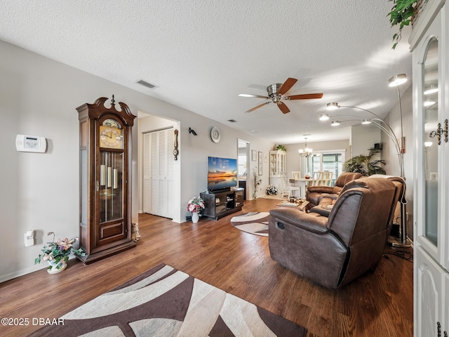 708 Egret Ct, Edgewater, FL 32141 - living room with a ceiling fan, wood finished floors, a chandelier, a textured ceiling, and baseboards