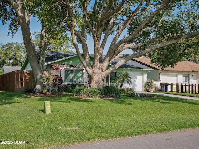 708 Egret Ct, Edgewater, FL 32141 - view of front of home with an attached garage, brick siding, concrete driveway, and roof with shingles