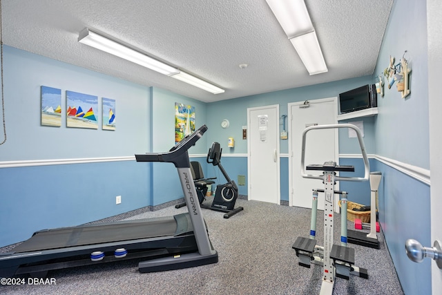 exercise room featuring a textured ceiling