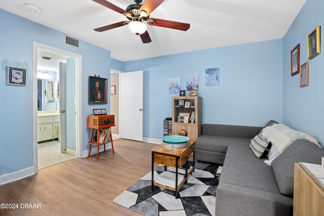 living room featuring ceiling fan and light wood-type flooring