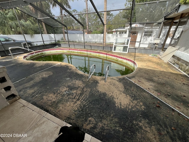 view of pool featuring a patio and glass enclosure