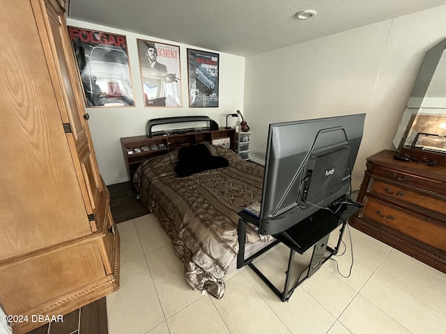 tiled bedroom with a textured ceiling